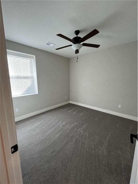 15653 Lakeside Dr, Basehor, KS 66007 - spare room with dark colored carpet and a ceiling fan
