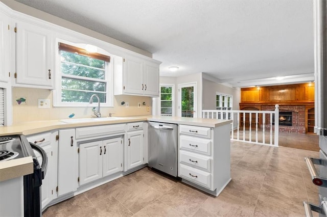 13942 W 113th St, Olathe, KS 66215 - kitchen with stainless steel dishwasher, a peninsula, decorative backsplash, white cabinets, and a textured ceiling