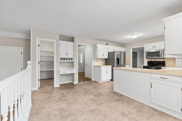 13942 W 113th St, Olathe, KS 66215 - kitchen featuring appliances with stainless steel finishes, a textured ceiling, white cabinets, and light countertops