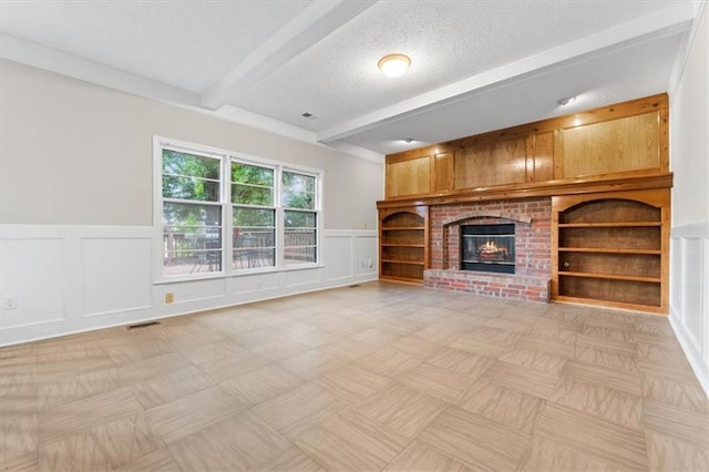 13942 W 113th St, Olathe, KS 66215 - unfurnished living room featuring beam ceiling, a decorative wall, a brick fireplace, a wainscoted wall, and built in shelves