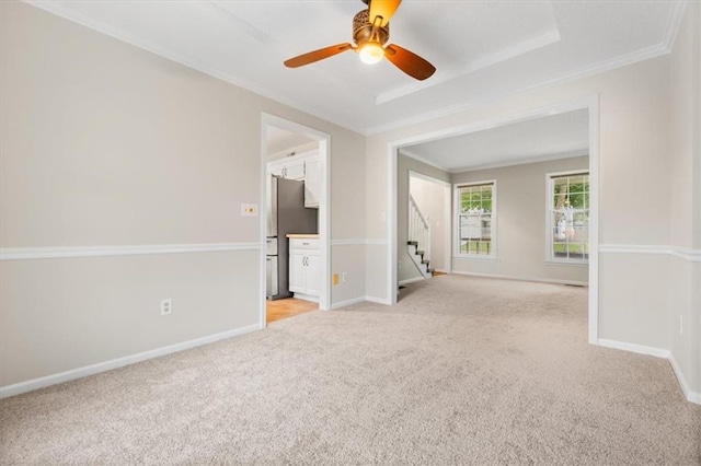 13942 W 113th St, Olathe, KS 66215 - spare room with light carpet, crown molding, stairs, and ceiling fan