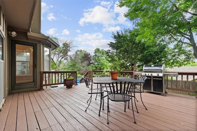 13942 W 113th St, Olathe, KS 66215 - wooden terrace with outdoor dining space and area for grilling