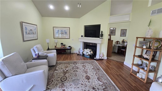 16810 NE 170th Ter, Holt, MO 64048 - living area featuring wood finished floors, a high end fireplace, high vaulted ceiling, and recessed lighting