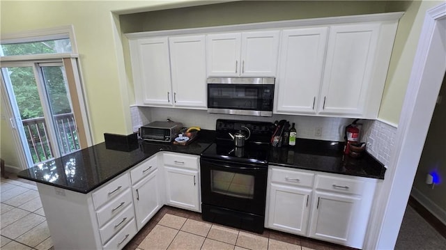 16810 NE 170th Ter, Holt, MO 64048 - kitchen featuring stainless steel microwave, black range with electric cooktop, a peninsula, and white cabinetry