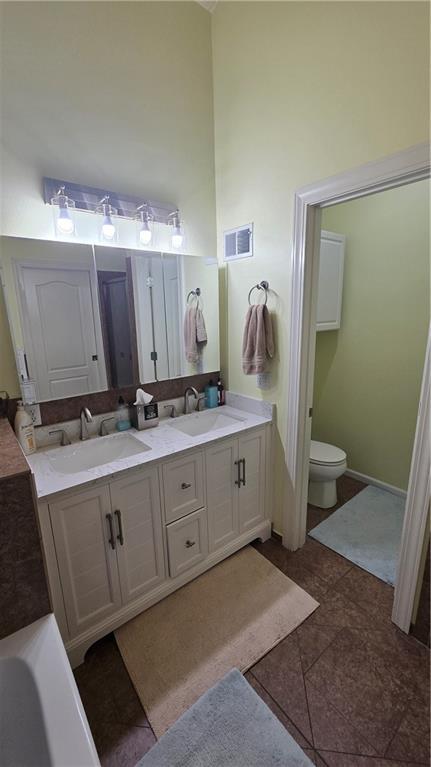 16810 NE 170th Ter, Holt, MO 64048 - bathroom with double vanity and a towering ceiling