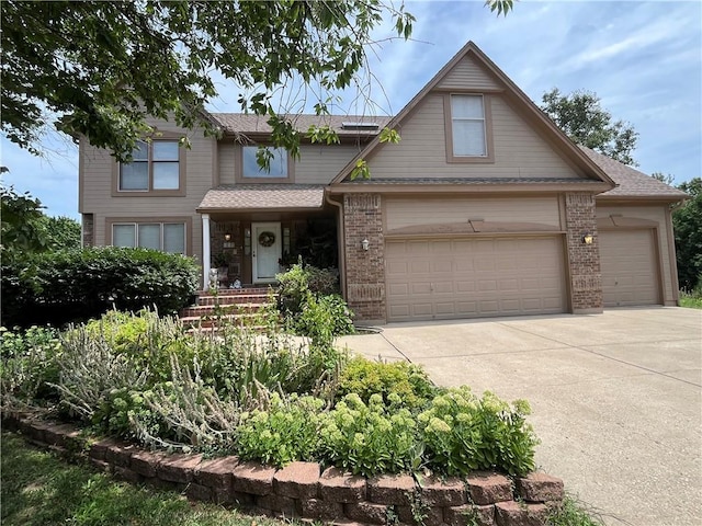 505 Williamsburg Dr, Lees Summit, MO 64063 - traditional-style house featuring concrete driveway, brick siding, a shingled roof, and an attached garage