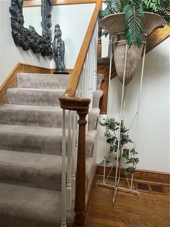 505 Williamsburg Dr, Lees Summit, MO 64063 - stairs with hardwood / wood-style floors and baseboards