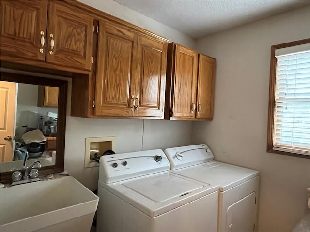 505 Williamsburg Dr, Lees Summit, MO 64063 - washroom featuring washing machine and clothes dryer, cabinet space, and a textured ceiling
