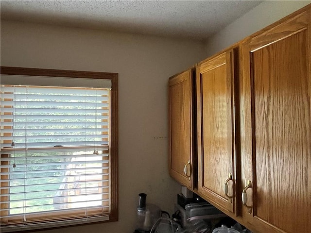 505 Williamsburg Dr, Lees Summit, MO 64063 - kitchen view of brown cabinets and a textured ceiling