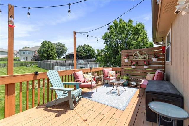 1903 NW Rosewood Dr, Grain Valley, MO 64029 - wooden terrace with outdoor lounge area and a fenced backyard