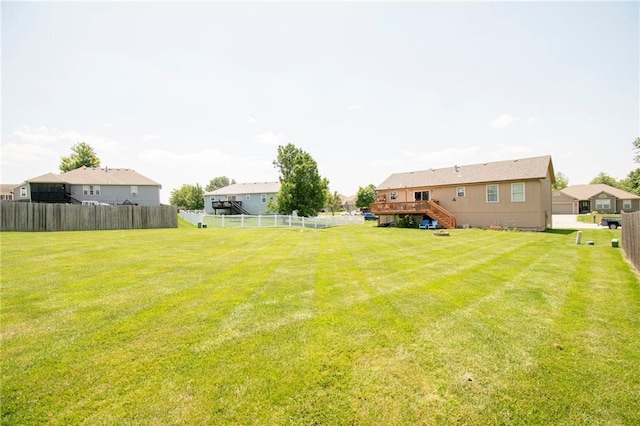 1903 NW Rosewood Dr, Grain Valley, MO 64029 - fenced backyard with stairway and a wooden deck