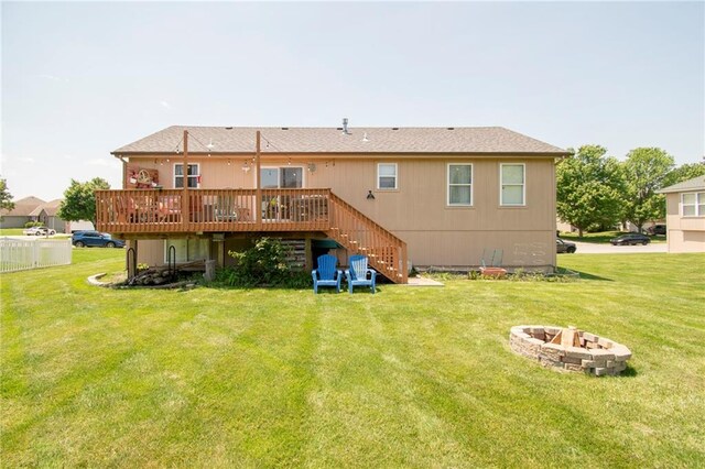 1903 NW Rosewood Dr, Grain Valley, MO 64029 - back of house with a fire pit, stairway, a deck, and a lawn
