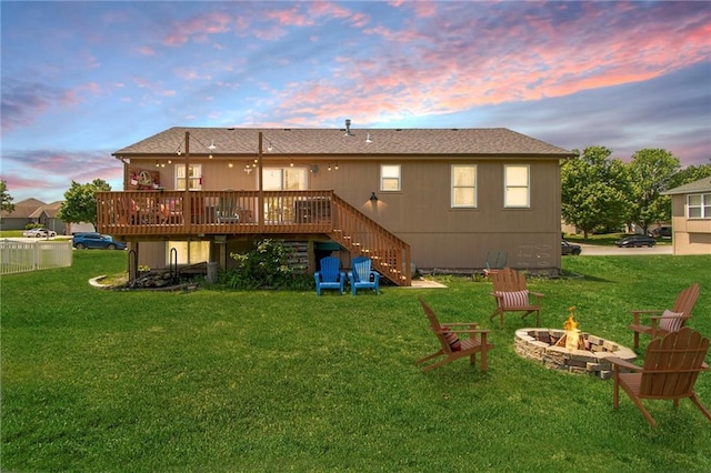 1903 NW Rosewood Dr, Grain Valley, MO 64029 - back of property featuring an outdoor fire pit, stairway, a deck, and a yard