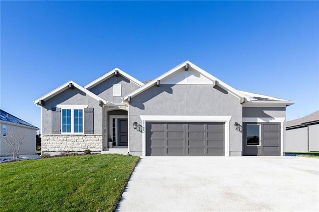 15323 W 171st Ter, Olathe, KS 66062 - view of front facade with a garage, driveway, stucco siding, a front lawn, and stone siding