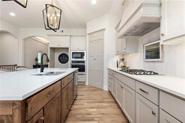 15323 W 171st Ter, Olathe, KS 66062 - kitchen featuring custom exhaust hood, appliances with stainless steel finishes, light wood-style flooring, light countertops, and recessed lighting