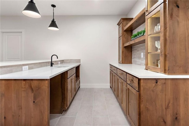 15323 W 171st Ter, Olathe, KS 66062 - kitchen with a peninsula, brown cabinets, open shelves, decorative light fixtures, and light tile patterned flooring