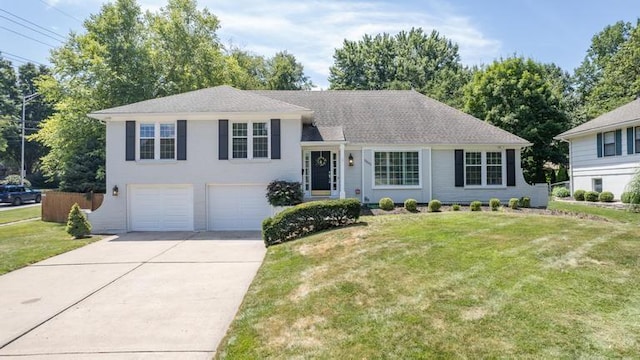5501 W 86th St, Overland Park, KS 66207 - tri-level home featuring driveway, a garage, and a front lawn