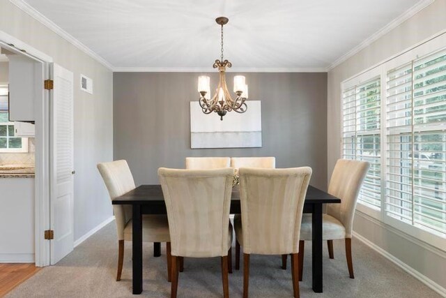 5501 W 86th St, Overland Park, KS 66207 - carpeted dining area with a chandelier, plenty of natural light, and ornamental molding