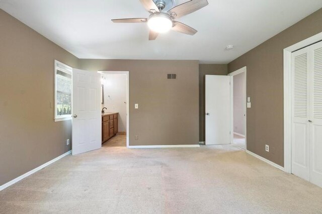 5501 W 86th St, Overland Park, KS 66207 - unfurnished bedroom with light colored carpet, ensuite bathroom, a closet, and ceiling fan