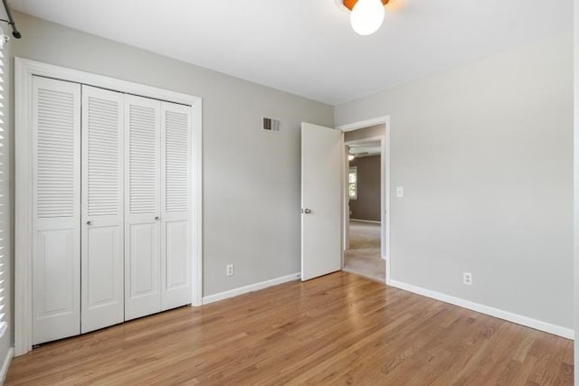 5501 W 86th St, Overland Park, KS 66207 - unfurnished bedroom with light wood finished floors and a closet