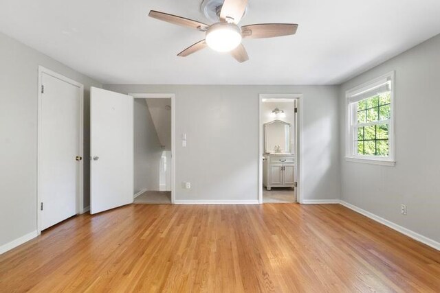 5501 W 86th St, Overland Park, KS 66207 - unfurnished bedroom featuring light wood finished floors, connected bathroom, and a ceiling fan