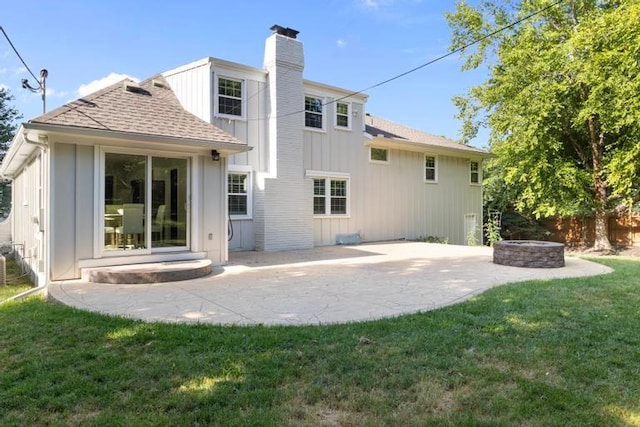 5501 W 86th St, Overland Park, KS 66207 - back of property with a patio area, a chimney, roof with shingles, an outdoor fire pit, and board and batten siding