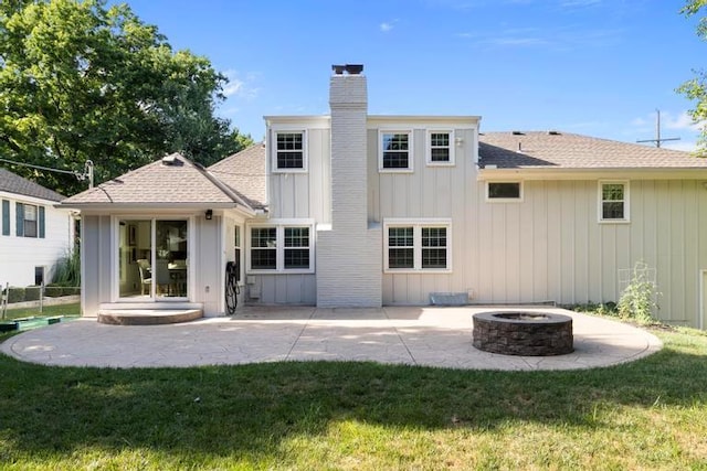 5501 W 86th St, Overland Park, KS 66207 - back of house with a chimney, a fire pit, a patio area, a lawn, and roof with shingles