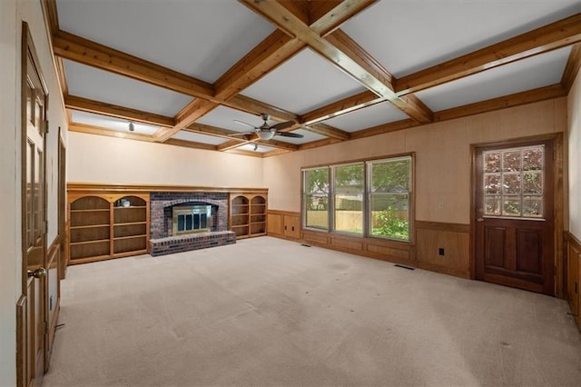 13217 S Locust St, Olathe, KS 66062 - unfurnished living room with a wainscoted wall, coffered ceiling, beamed ceiling, healthy amount of natural light, and a fireplace