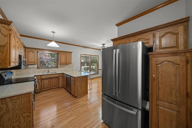 13217 S Locust St, Olathe, KS 66062 - kitchen featuring stainless steel appliances, a peninsula, light wood-style flooring, backsplash, and brown cabinets