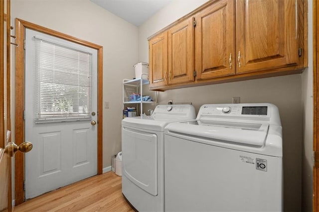 13217 S Locust St, Olathe, KS 66062 - laundry room featuring washer and dryer, light wood-style flooring, and cabinet space