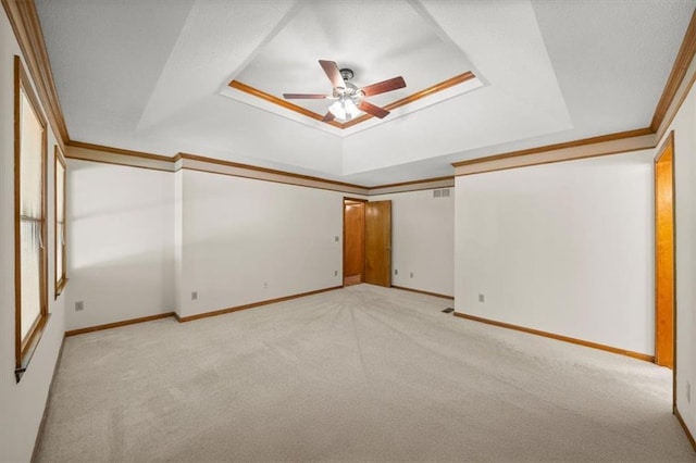 13217 S Locust St, Olathe, KS 66062 - unfurnished room featuring a raised ceiling, light colored carpet, ceiling fan, and crown molding