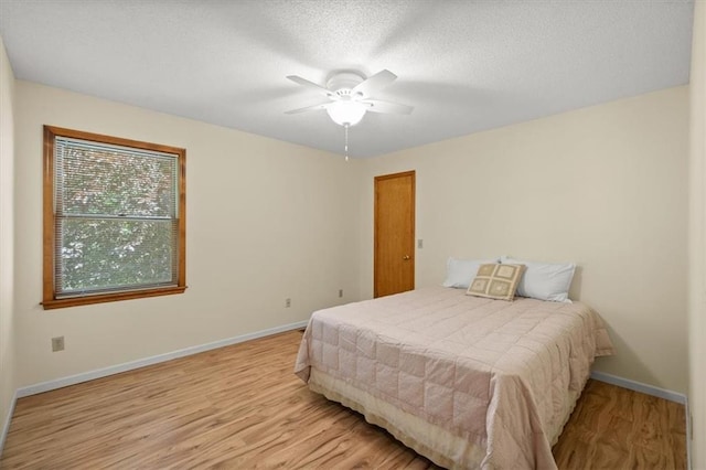 13217 S Locust St, Olathe, KS 66062 - bedroom with wood finished floors, a ceiling fan, and a textured ceiling