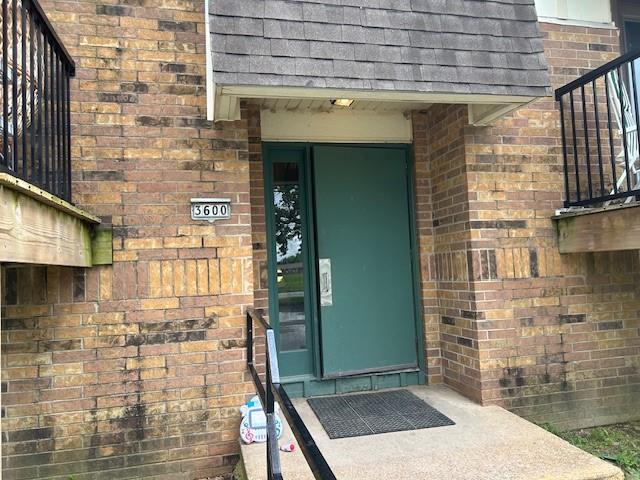 3600 Gabriel Ave Unit 303, Parsons, KS 67357 - entrance to property with brick siding and a shingled roof