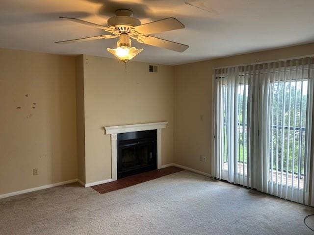 3600 Gabriel Ave Unit 303, Parsons, KS 67357 - unfurnished living room with carpet flooring, a fireplace with flush hearth, and ceiling fan
