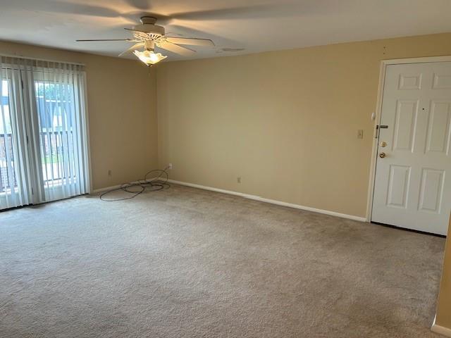 3600 Gabriel Ave Unit 303, Parsons, KS 67357 - carpeted empty room featuring ceiling fan and baseboards