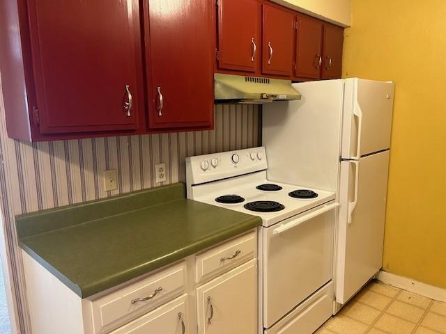 3600 Gabriel Ave Unit 303, Parsons, KS 67357 - kitchen featuring white range with electric cooktop, under cabinet range hood, and wallpapered walls