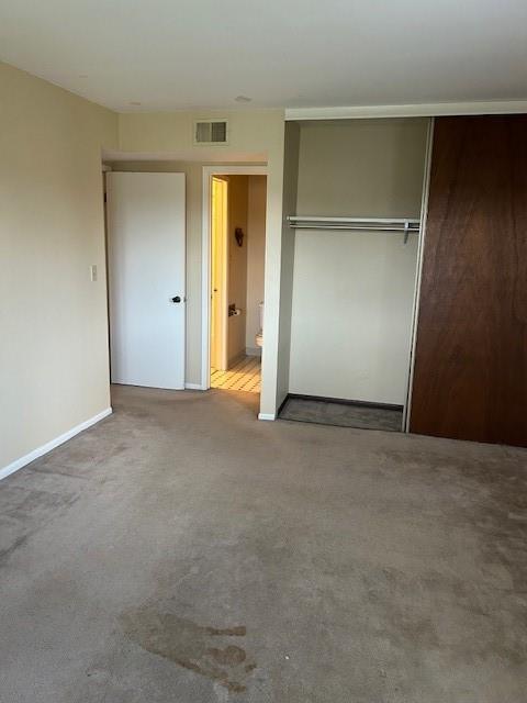 3600 Gabriel Ave Unit 303, Parsons, KS 67357 - unfurnished bedroom with a closet and carpet floors