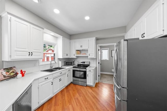 14522 W 61st St, Shawnee, KS 66216 - kitchen featuring appliances with stainless steel finishes, healthy amount of natural light, white cabinetry, and recessed lighting