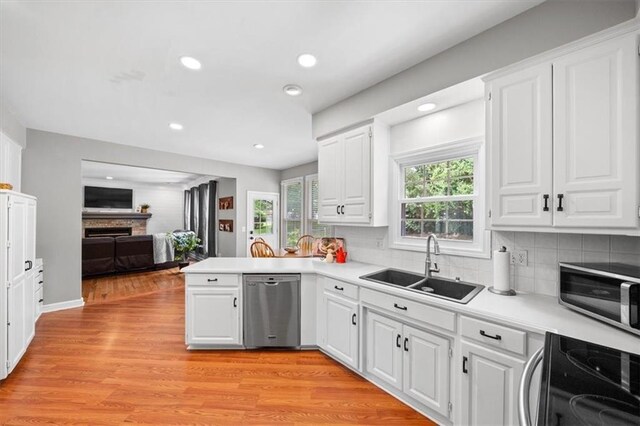 14522 W 61st St, Shawnee, KS 66216 - kitchen with dishwasher, electric stove, a fireplace, white cabinetry, and recessed lighting