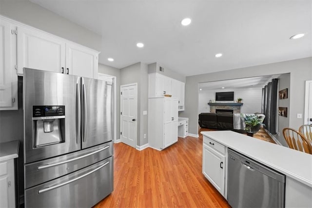 14522 W 61st St, Shawnee, KS 66216 - kitchen featuring stainless steel appliances, light countertops, white cabinetry, and recessed lighting