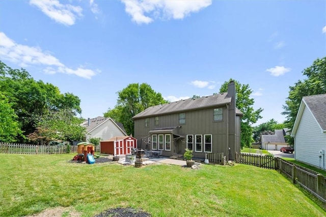 14522 W 61st St, Shawnee, KS 66216 - back of property with a shed, a patio area, a fenced backyard, and a chimney