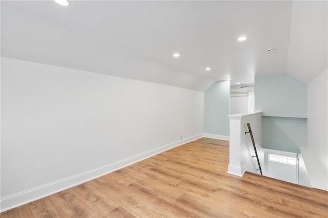 217 W 9th St, Ottawa, KS 66067 - bonus room with lofted ceiling, light wood-style floors, and recessed lighting