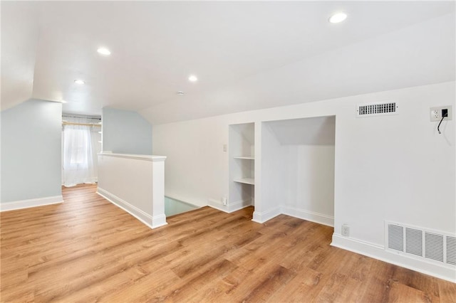 217 W 9th St, Ottawa, KS 66067 - bonus room with lofted ceiling, light wood-type flooring, recessed lighting, and built in shelves