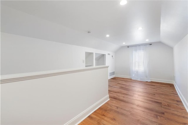 217 W 9th St, Ottawa, KS 66067 - bonus room with light wood finished floors, recessed lighting, and lofted ceiling
