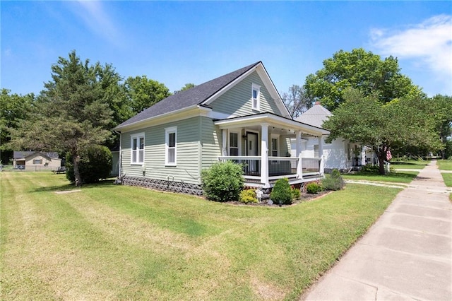 217 W 9th St, Ottawa, KS 66067 - view of home's exterior featuring a porch and a lawn