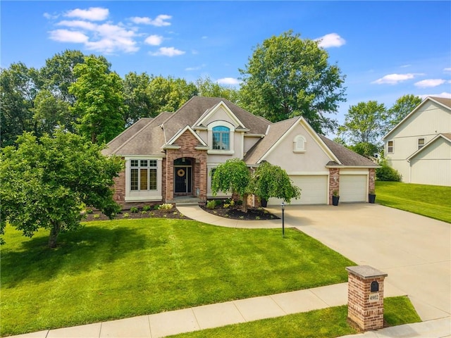 4902 Corinth Dr, Saint Joseph, MO 64506 - traditional-style home featuring stucco siding, concrete driveway, a front lawn, an attached garage, and brick siding