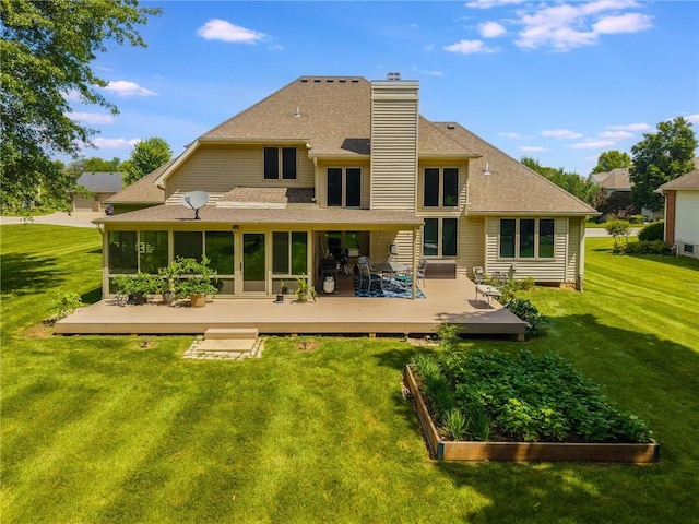 4902 Corinth Dr, Saint Joseph, MO 64506 - back of property featuring a garden, roof with shingles, a chimney, a deck, and a yard