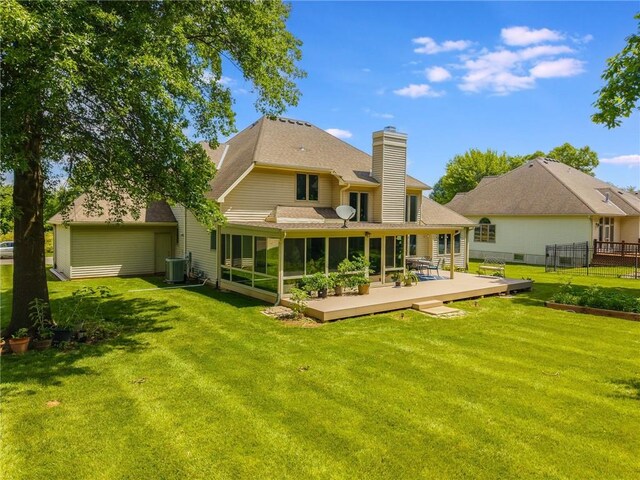4902 Corinth Dr, Saint Joseph, MO 64506 - rear view of property with a chimney, a sunroom, a shingled roof, and a deck