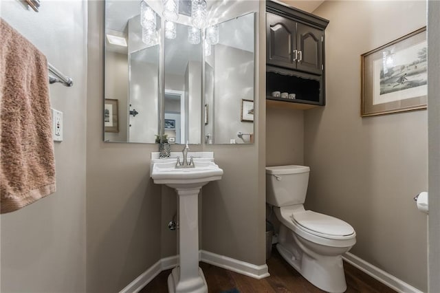 4902 Corinth Dr, Saint Joseph, MO 64506 - half bathroom featuring toilet and wood finished floors