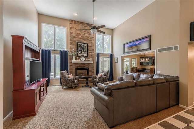 4902 Corinth Dr, Saint Joseph, MO 64506 - living area with a high ceiling, ceiling fan, a large fireplace, and carpet flooring